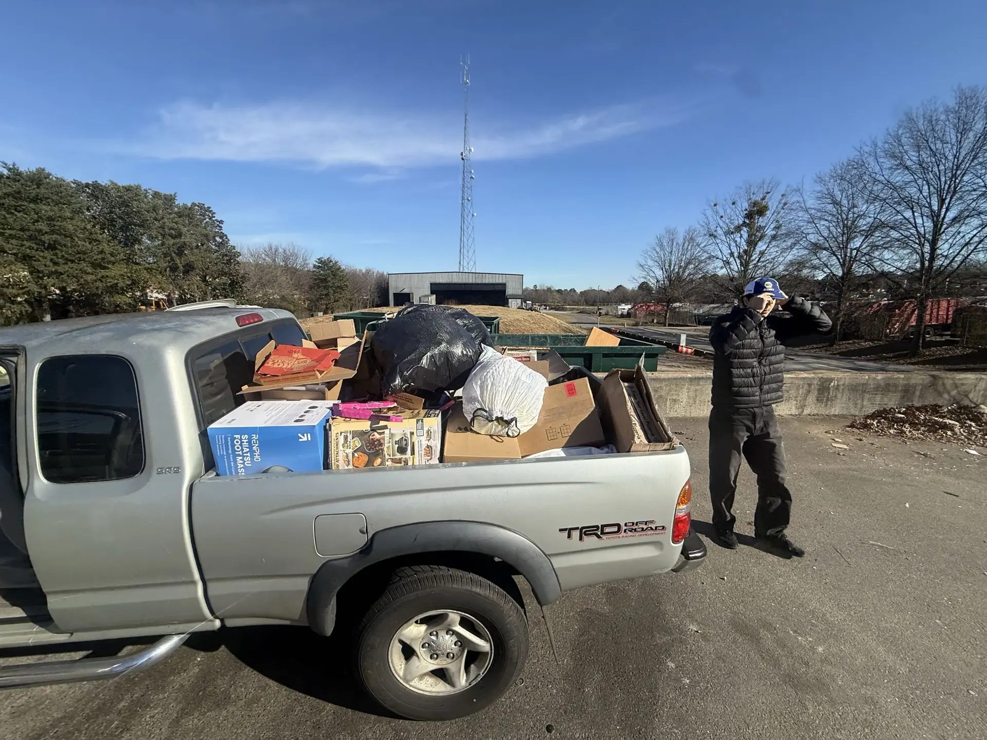 Bad Boys Junk Removal truck fully loaded with boxes, bags and large junk at a North Atlanta disposal site