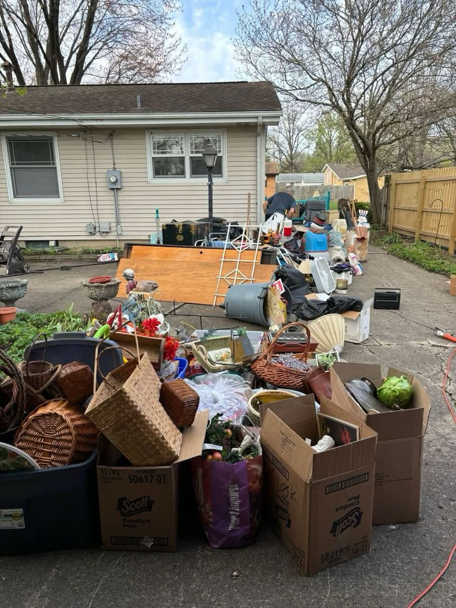 Driveway filled with boxes, baskets and household items ready for a moving cleanout in North Atlanta