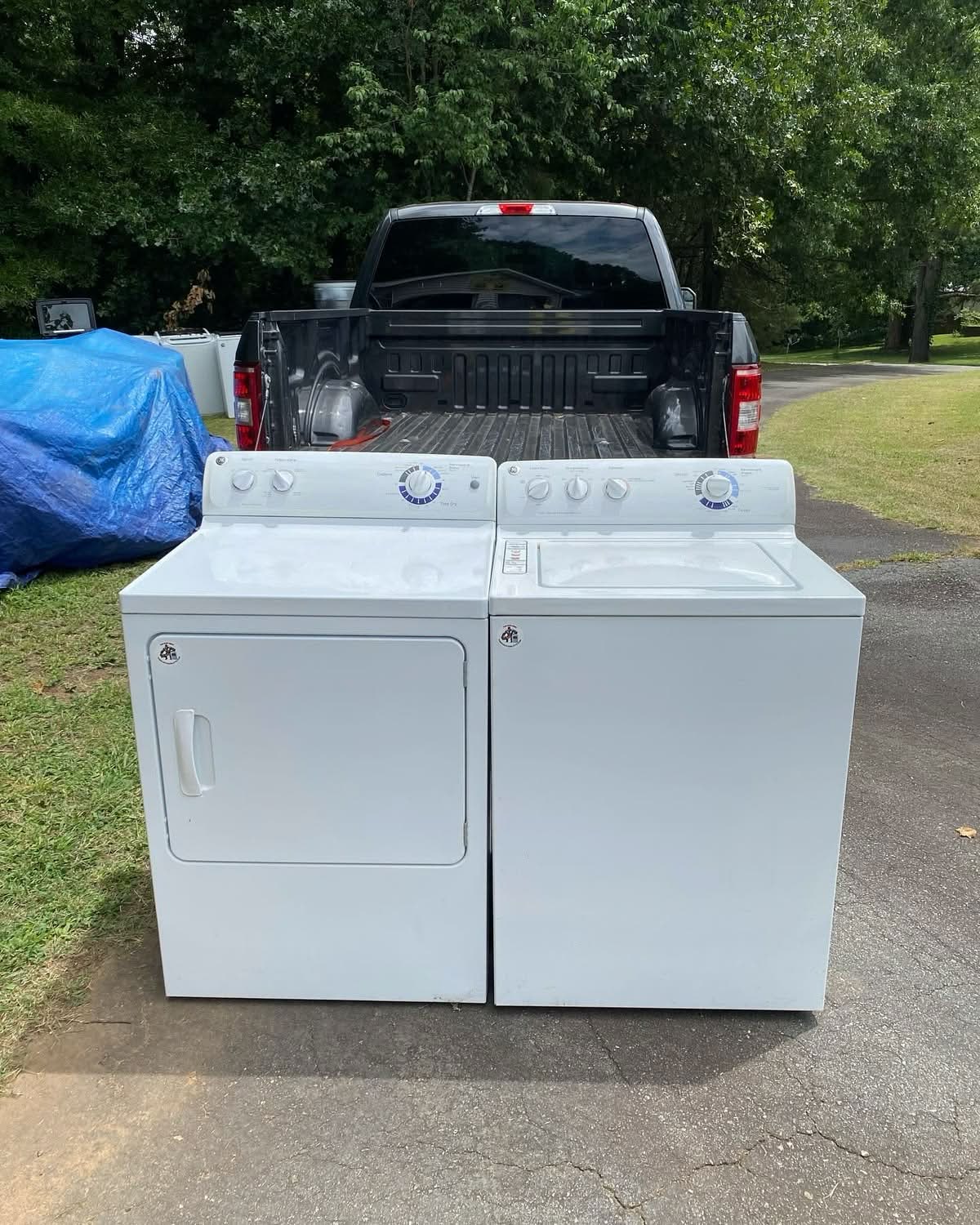 Bad Boys Junk Removal washer and dryer set ready for pickup in front of a truck in North Atlanta