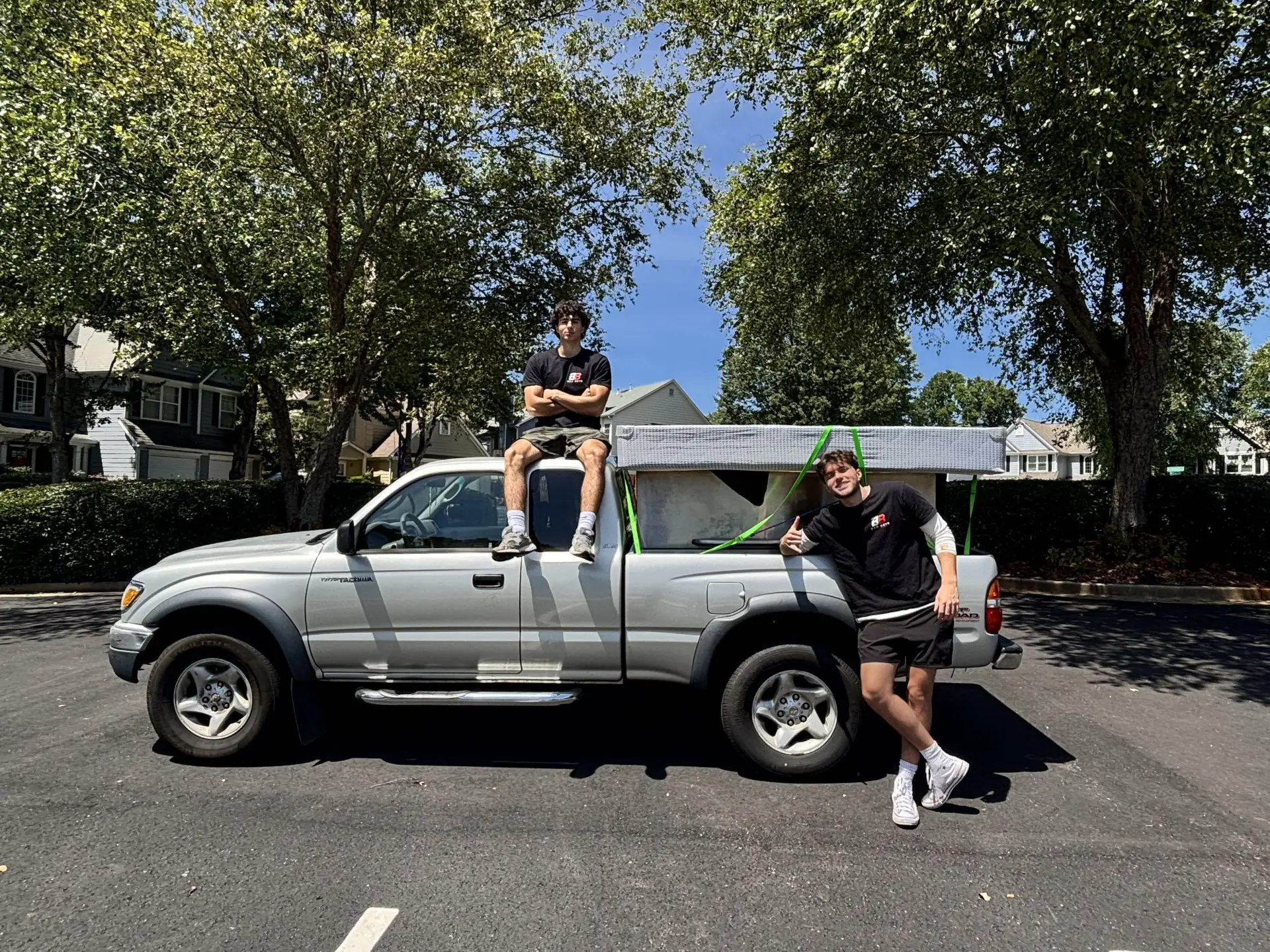 Bad Boys Junk Removal owners with a loaded truck on a residential furniture and household junk removal job